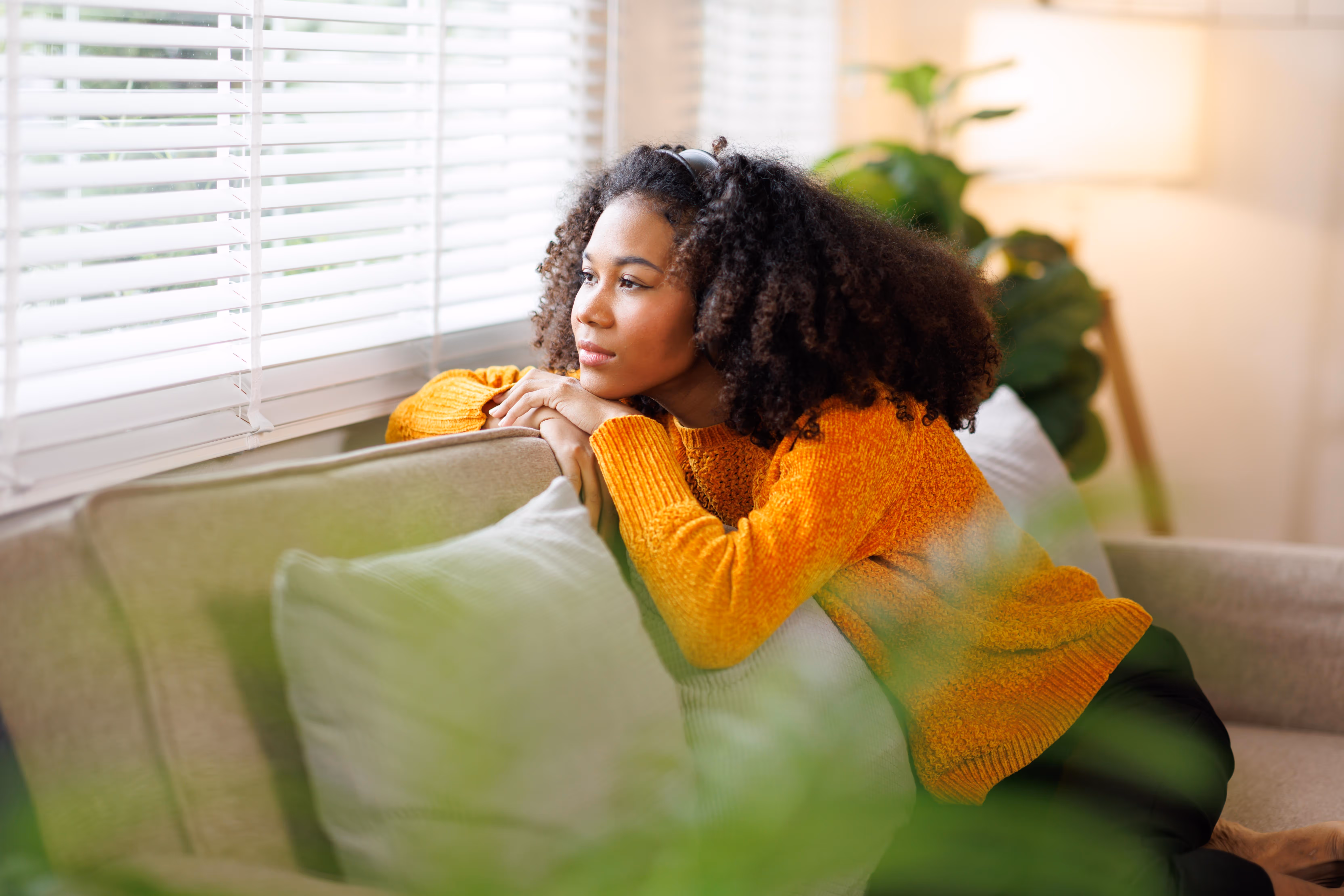 woman looking out of window stock image
