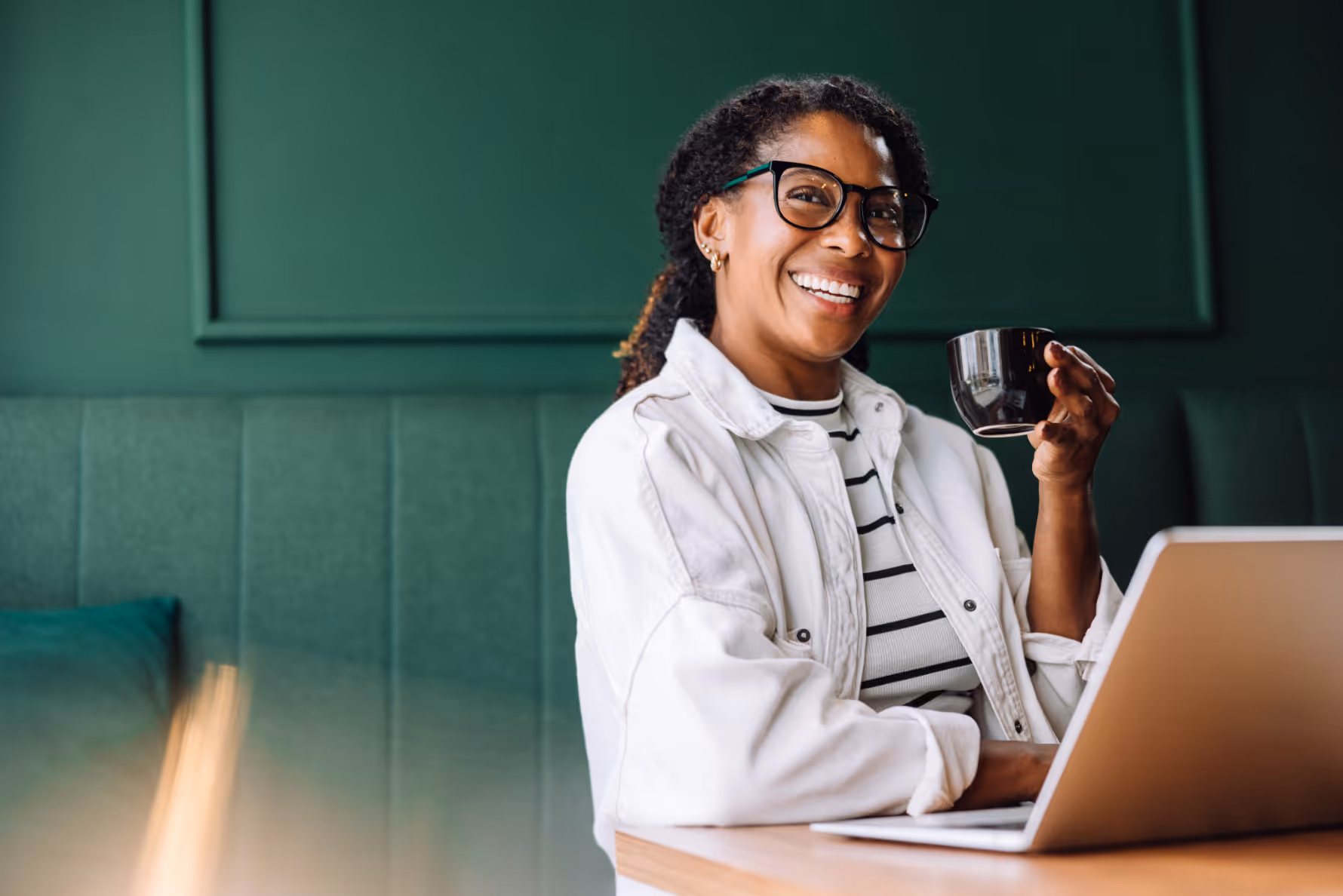 Woman with computer holding a mug stock image