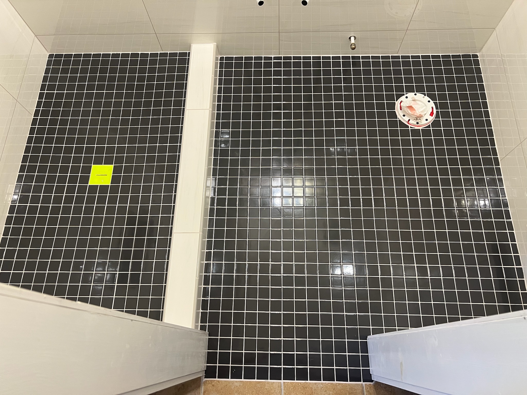 Floor with black square tiles and white grout.