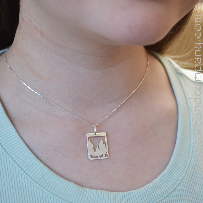 neckline of a woman wearing silver jewelry
