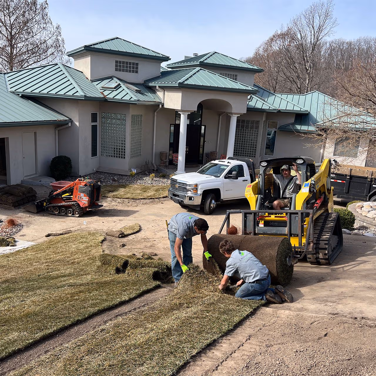Landmark Lawncare professional lawn maintenance team working on residential property
