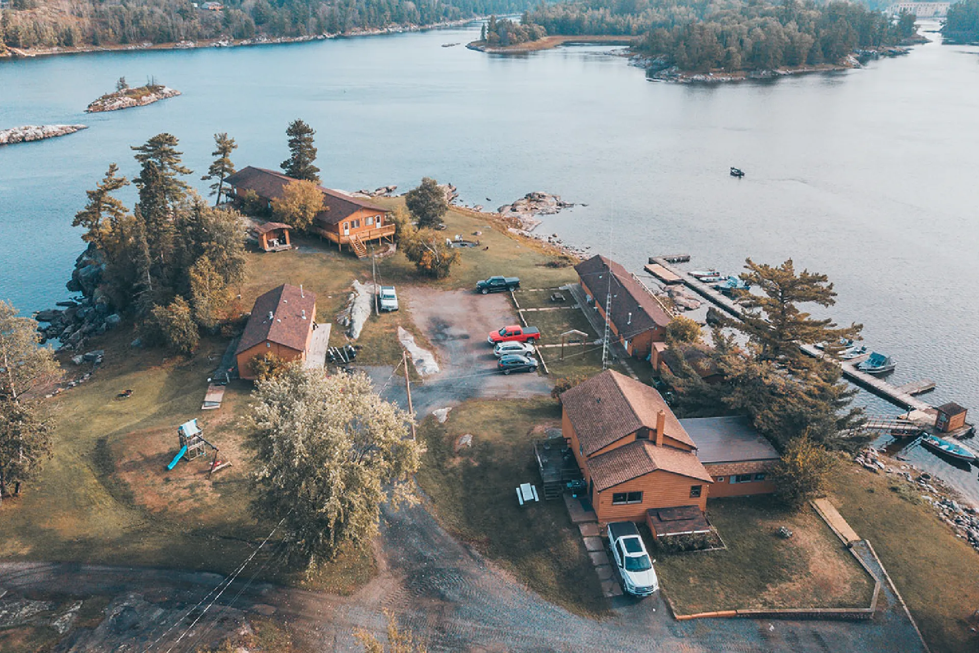 Aerial view of Perch Bay Resort cabins, docks, boats and rocky shoreline.