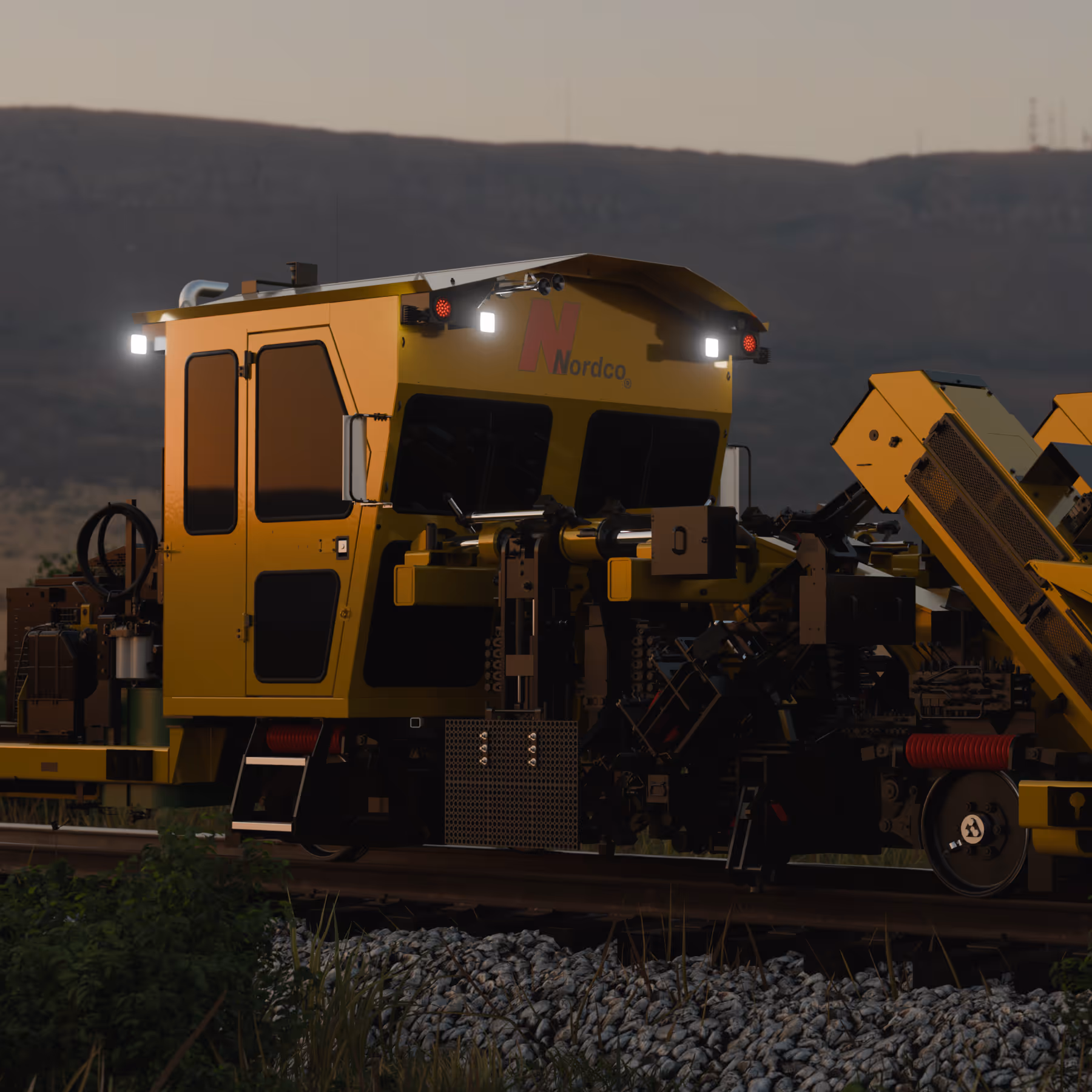 Yellow Nordco railway maintenance vehicle on tracks at dusk with illuminated lights.