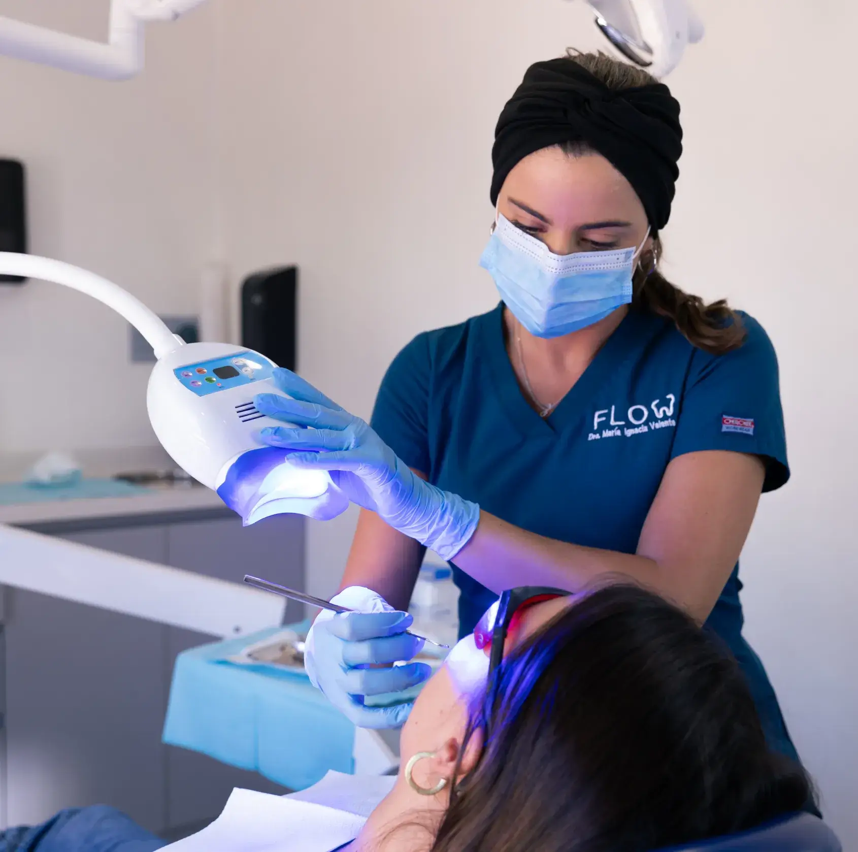 a woman getting her teeth checked by a dentist