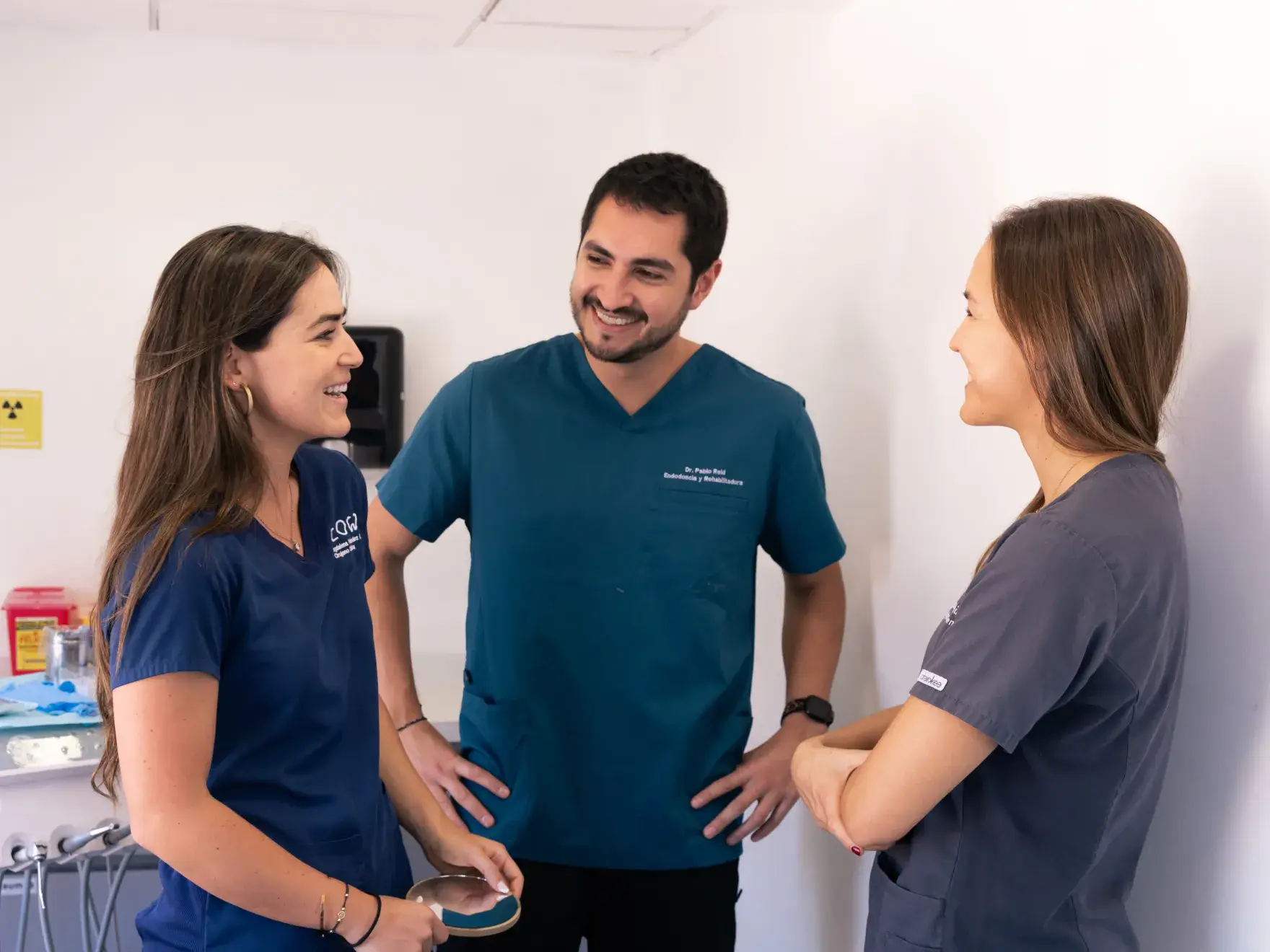 a man and two women standing next to each other