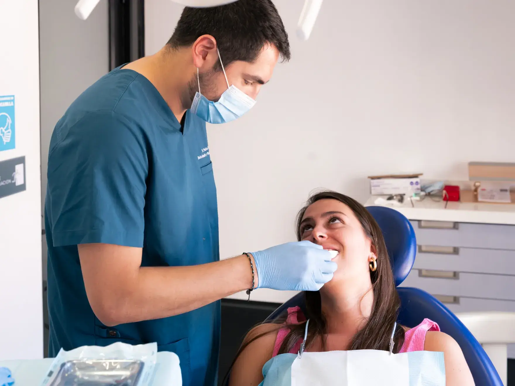 a woman in a dentist chair getting her teeth checked