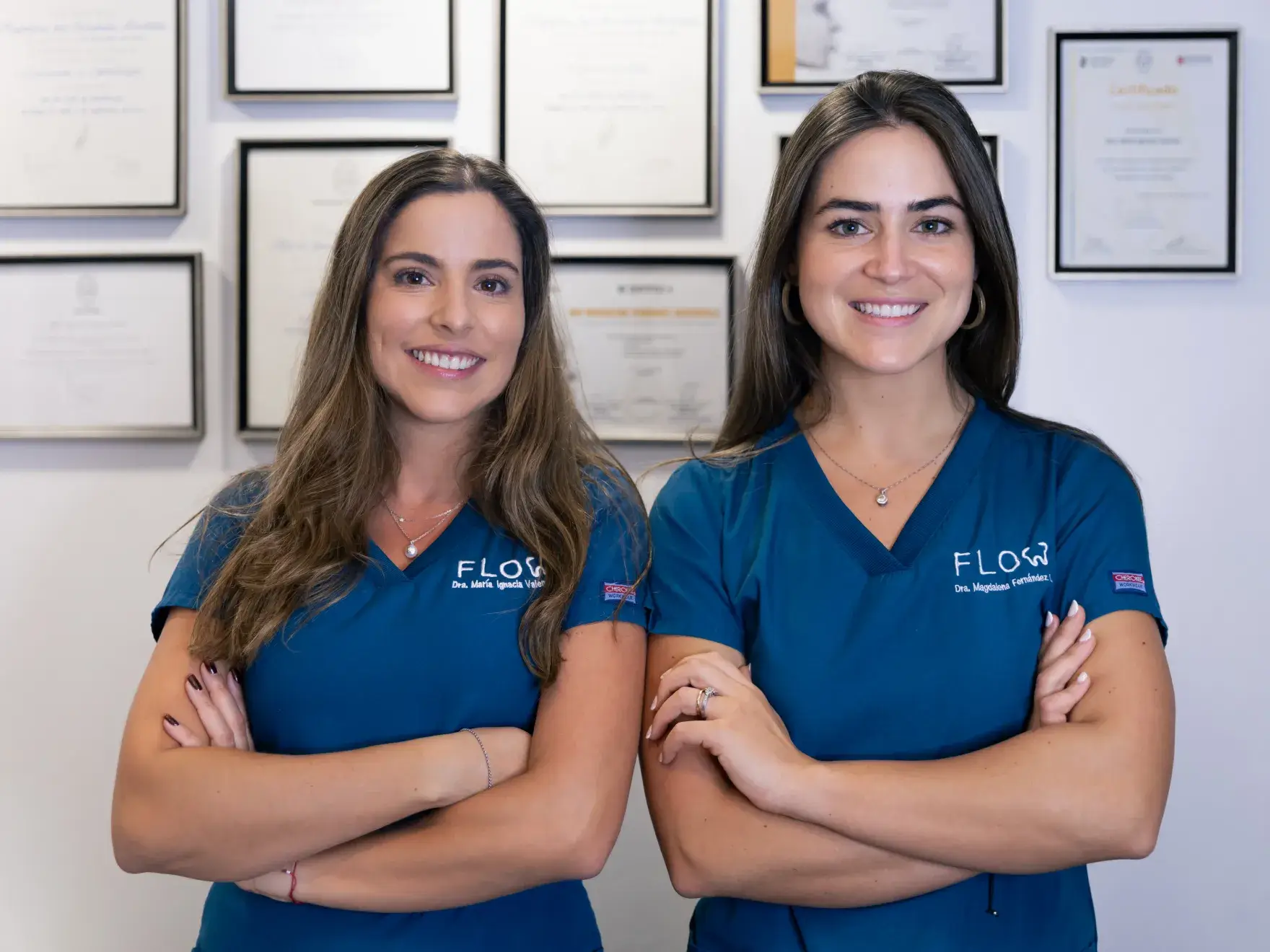 two women in blue scrubs posing for a picture