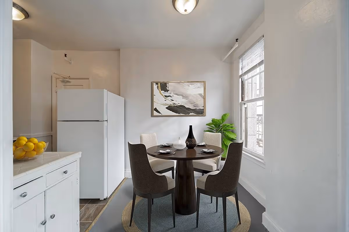 kitchen with white cabinets and table with chairs
