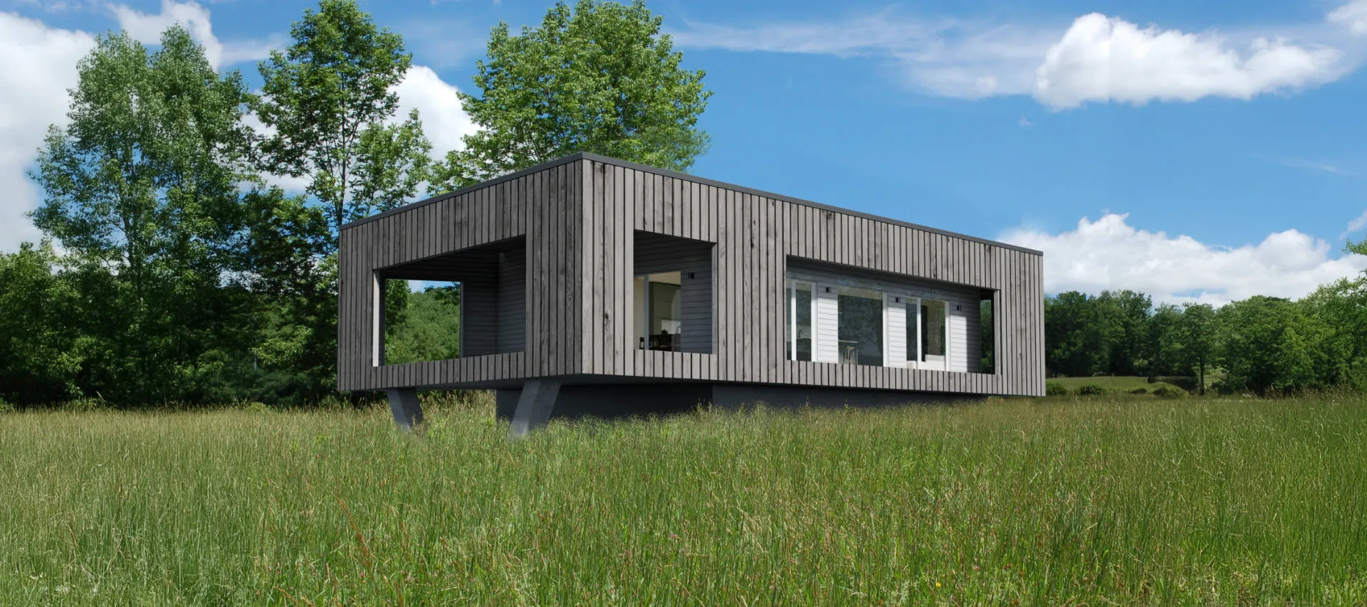 Modern elevated wooden house with large windows in a grassy field under a blue sky.