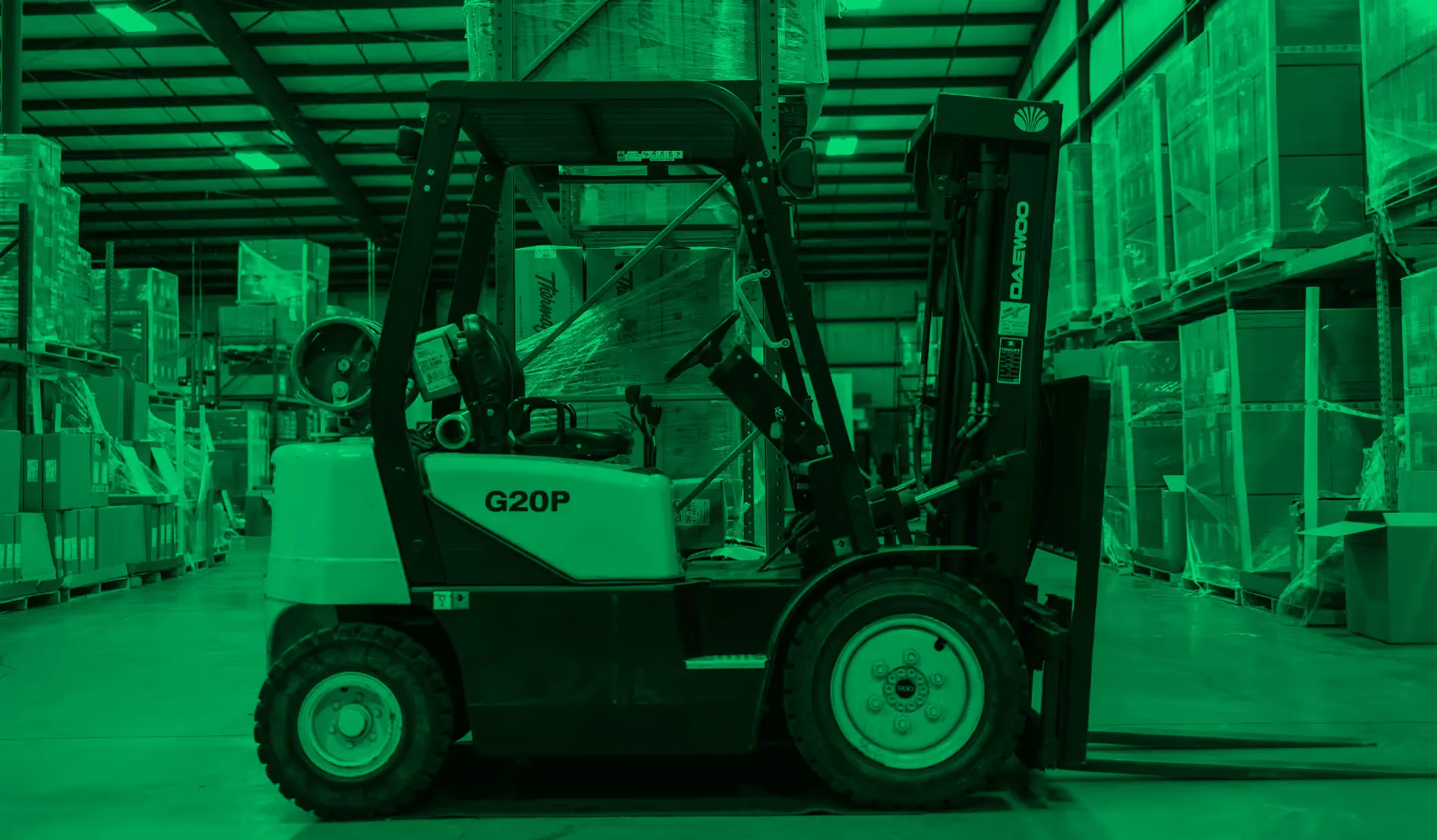 Worker in a warehouse organizing small items on labeled shelves.