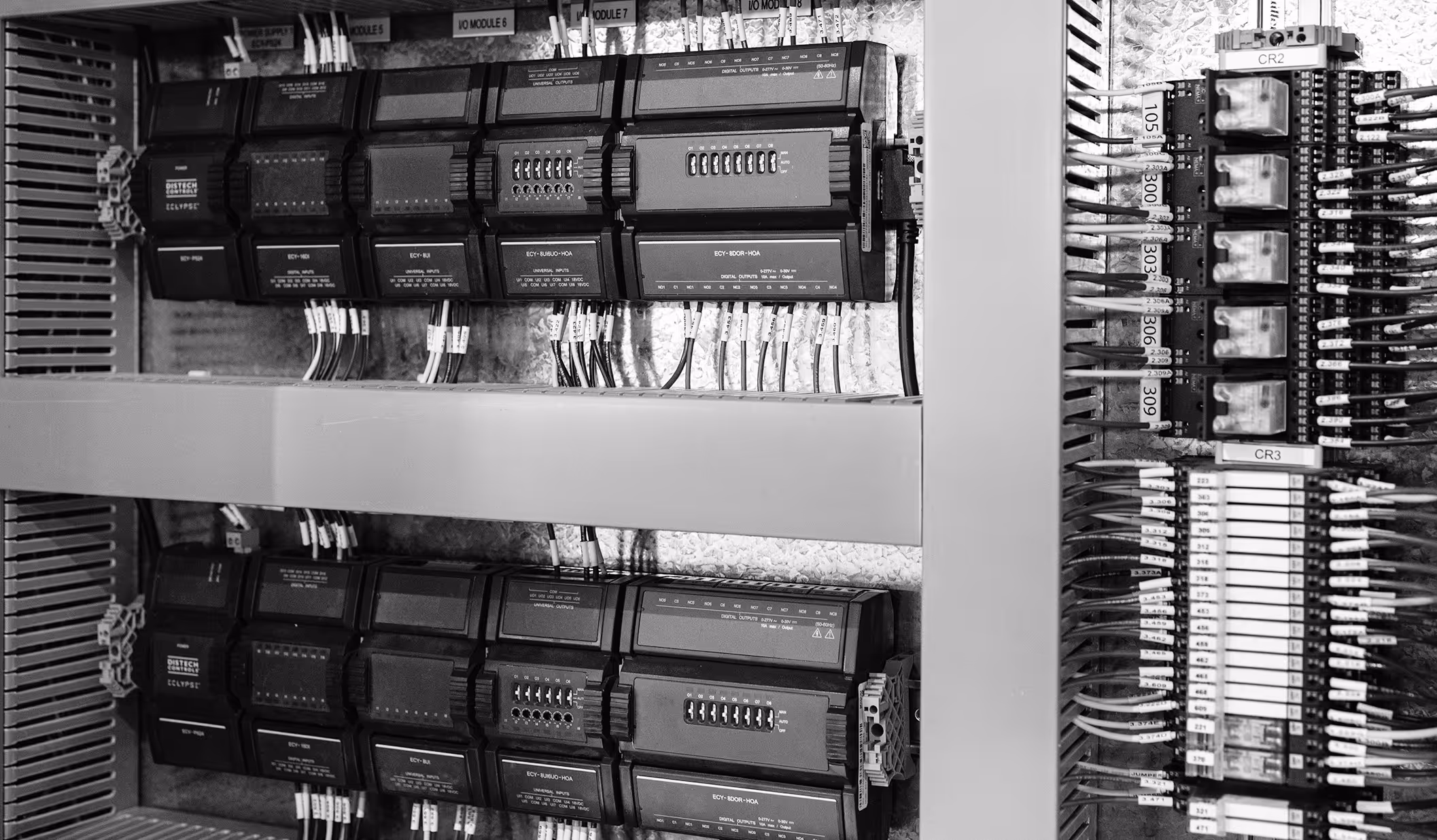 Close-up of an electrical control panel with wiring, labeled modules, and circuit relays.