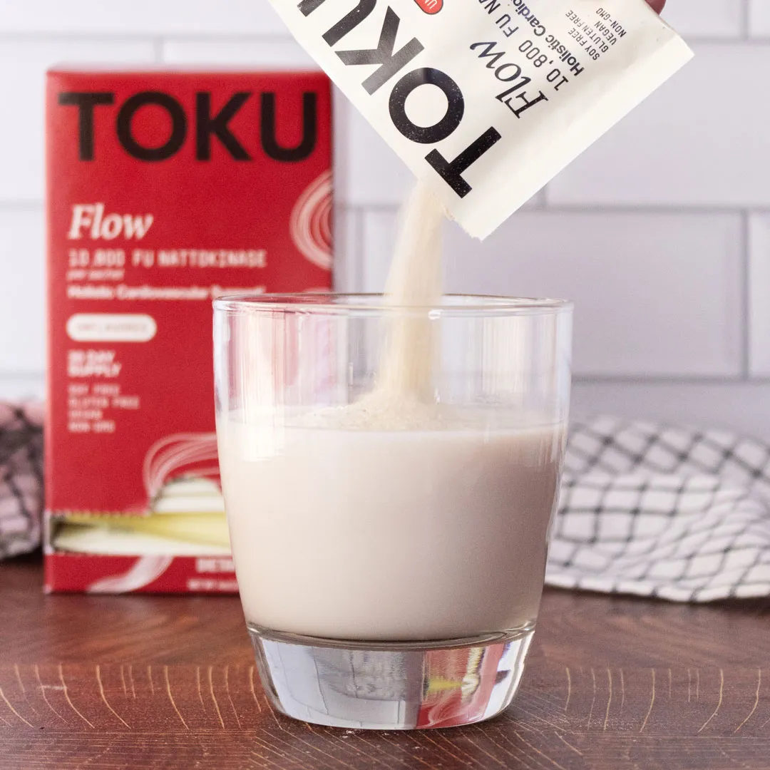Toku Flow Nattokinase Supplement 10,800 FU, a clinically relevant dose. Shown as a drink powder in glass. 