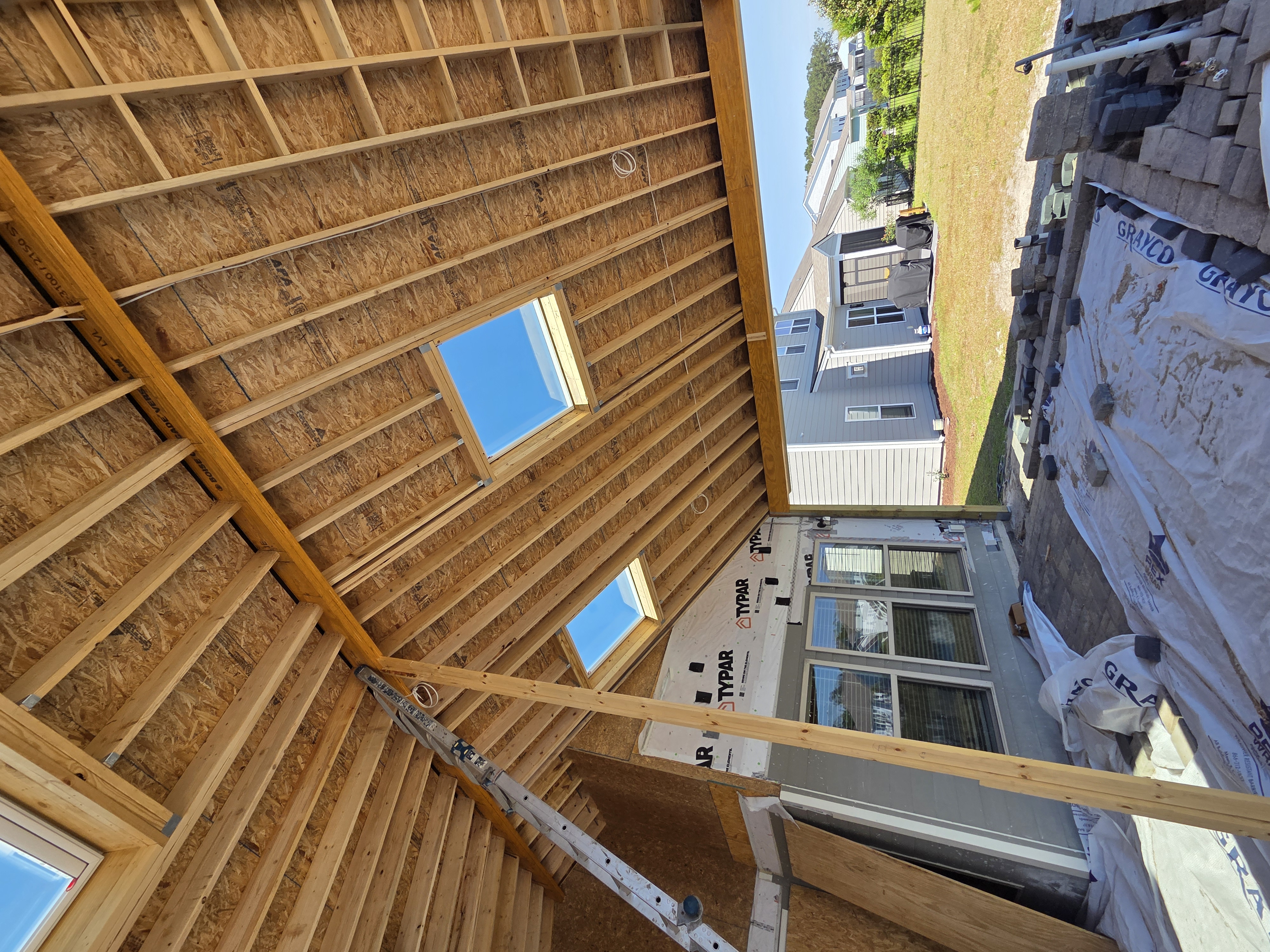 Curved white concrete architecture against a clear blue sky, showcasing smooth lines and modern design elements.