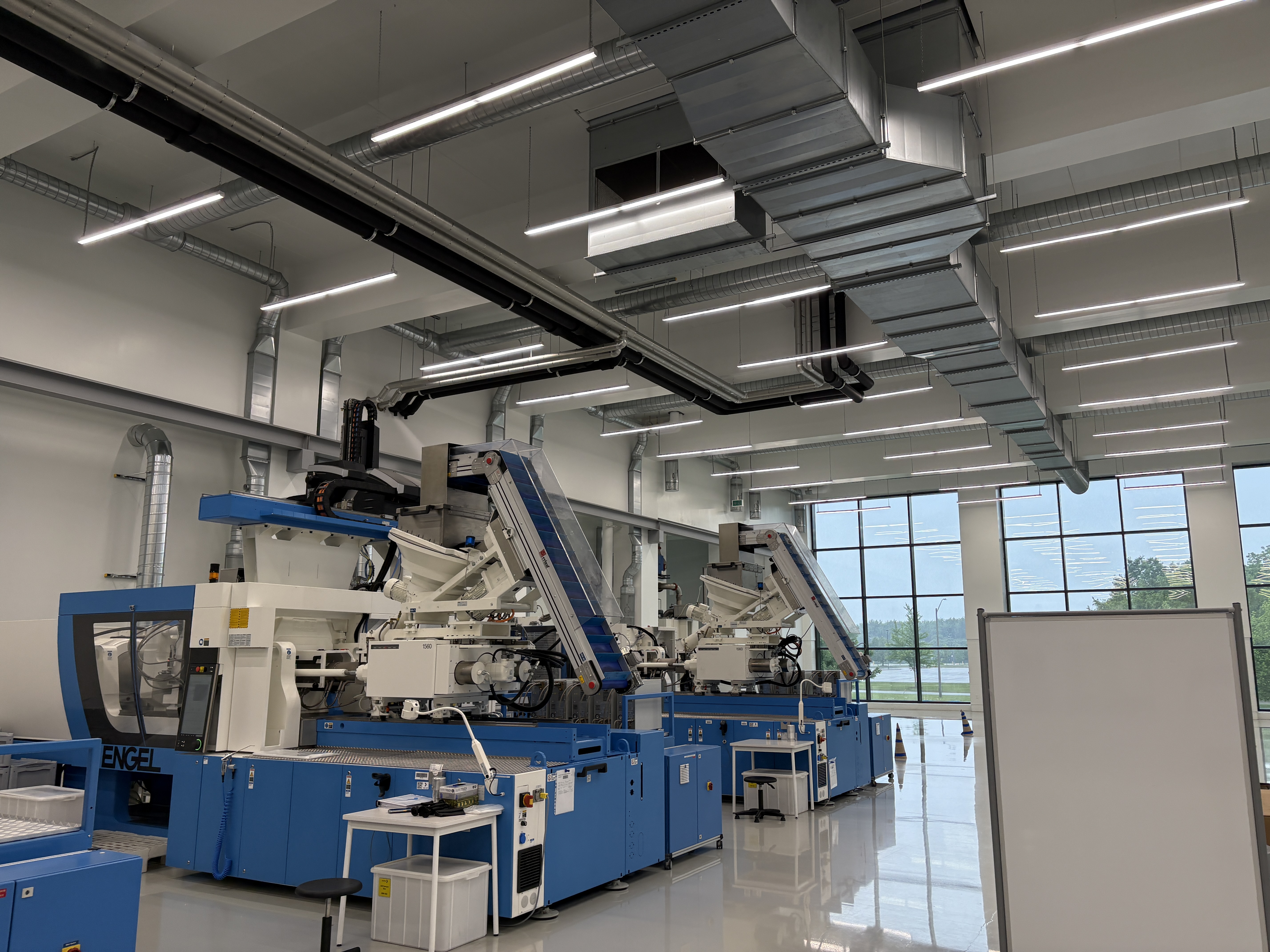 Liquid silicone injection moulding machines inside a GMP-compliant cleanroom with aluminum honeycomb ceiling panels — Moddulx panel supply, London Ontario