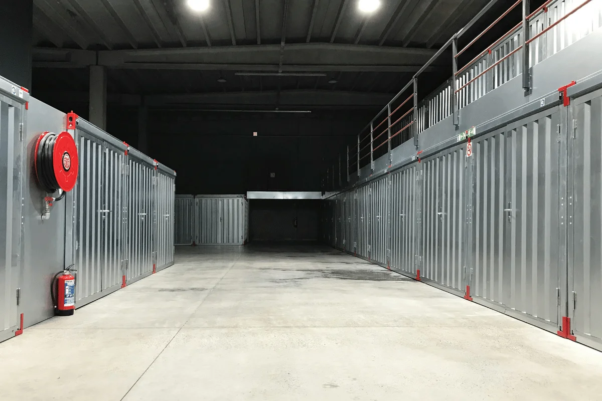 Interior of an industrial storage facility with metal units and concrete flooring.