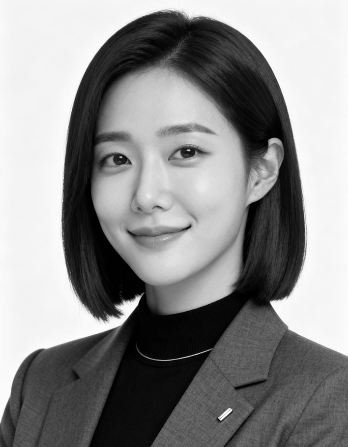 Portrait of a smiling woman with straight dark hair wearing a blazer and black turtleneck.