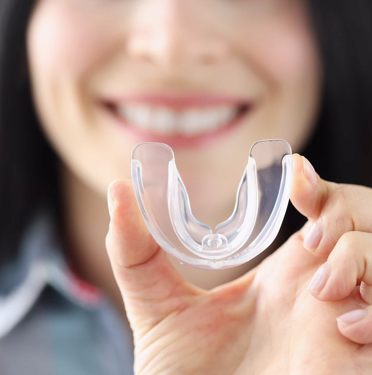 Patient holding up a dental guard in West San Jose at Pries Dental Care