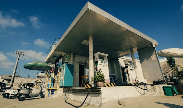 Gas station with scooters under blue sky