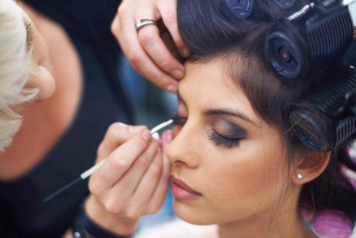 Woman having makeup applied to her face