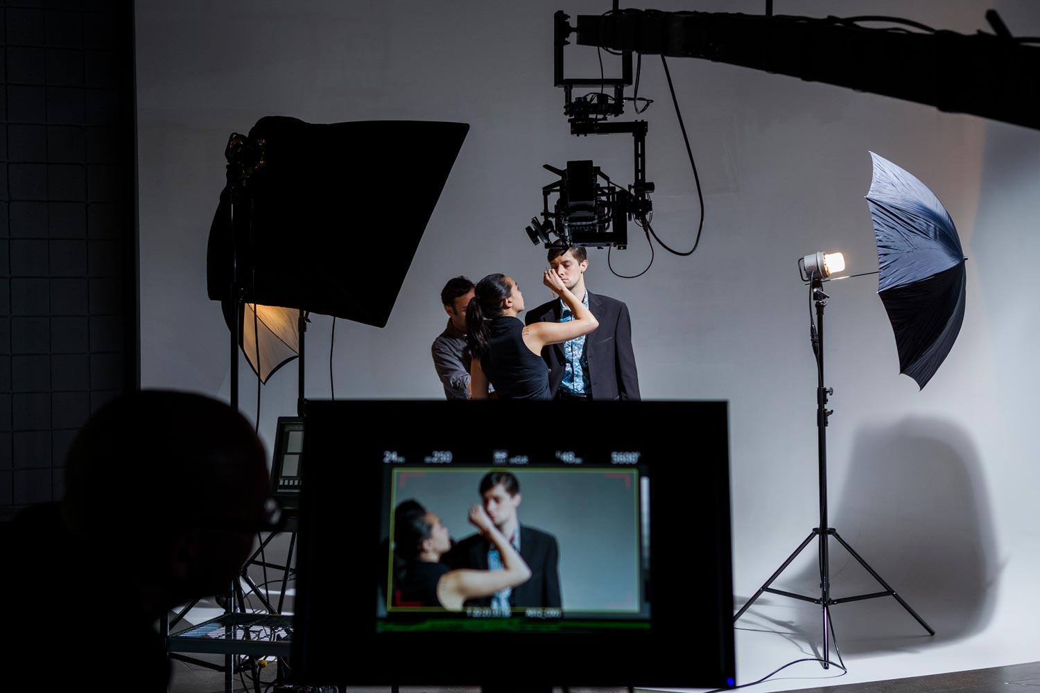 a man having his face touched-up in-between takes.