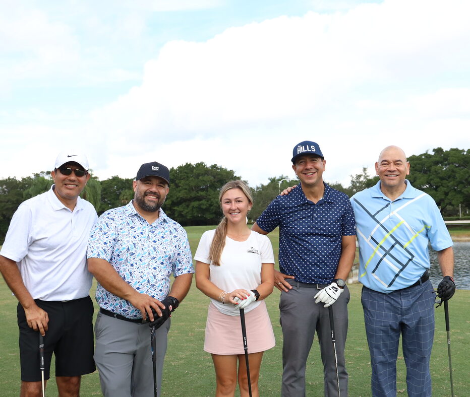 A group of participants with their clubs on the course at the 2025 charity golf tournament.