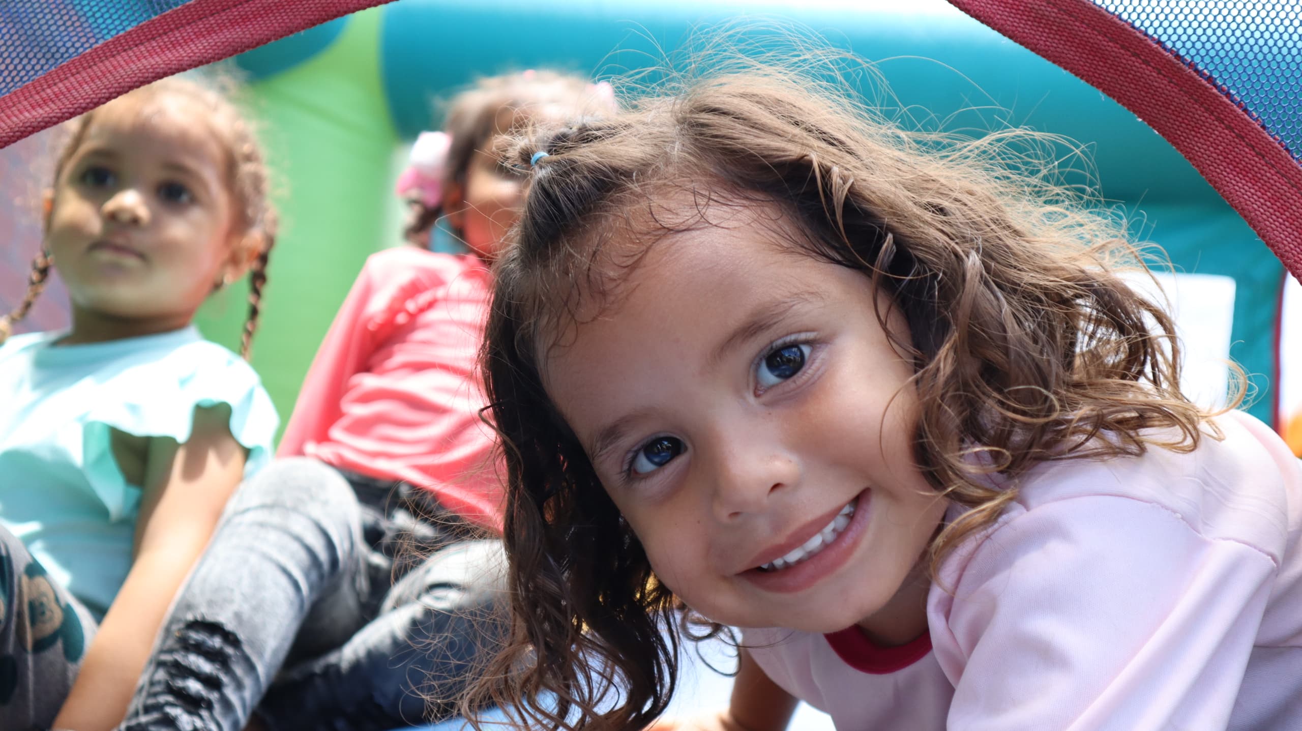 A girl smiling at a Victoria Venezuela Foundation event in Venezuela