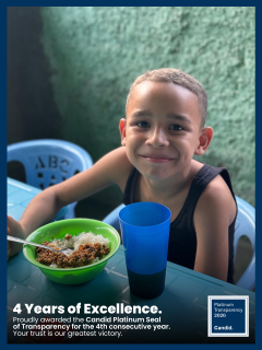 A smiling boy at a table with a meal. Overlay: 4 Years of Excellence, Candid Platinum Seal of Transparency for the fourth year in a row.