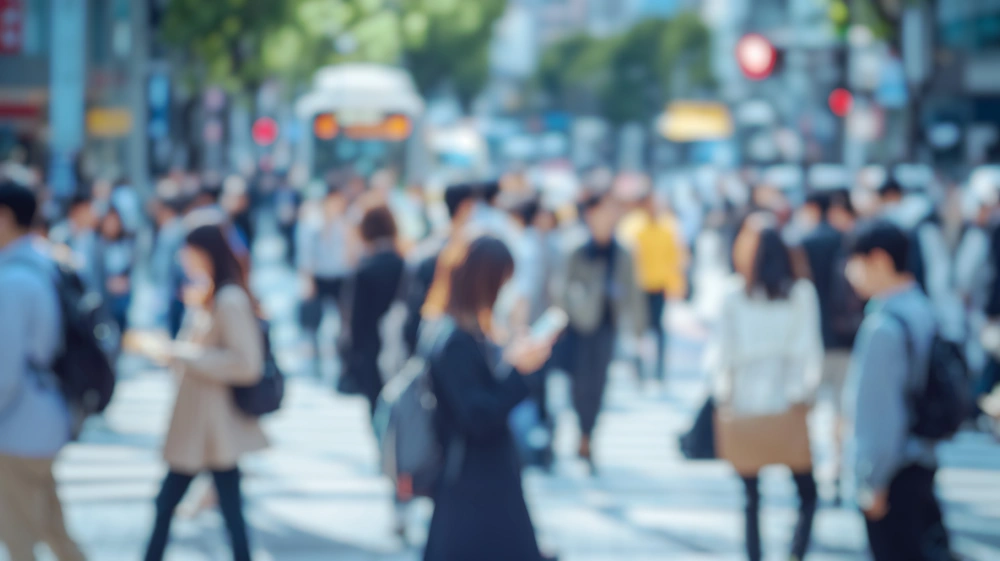 Soft focus on a busy city street with people walking and standing