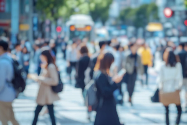Soft focus on a busy city street with people walking and standing