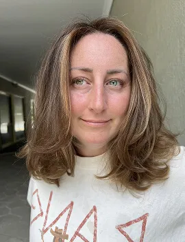 Warm brunette tint colour with soft caramel tones on medium-length hair at Jura Draco Gold Coast