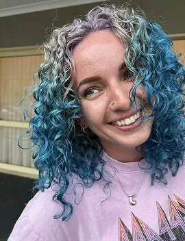 Teal blue and silver creative colour on curly hair at Jura Draco Gold Coast creative colour salon
