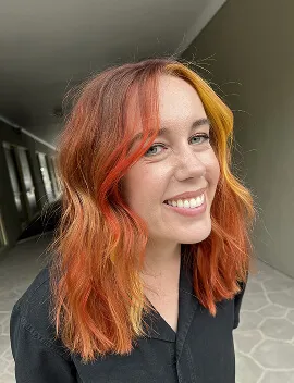 Copper and orange creative colour with golden accents on wavy mid-length hair by Jura Draco Gold Coast