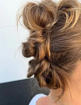 Romantic twisted upstyle with soft face-framing pieces for event hair at Jura Draco Gold Coast salon