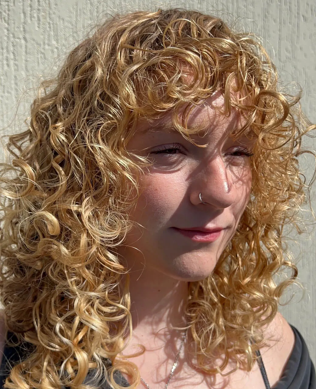 Golden blonde curly hair with dimensional highlights by Jura Draco Gold Coast blonde specialist
