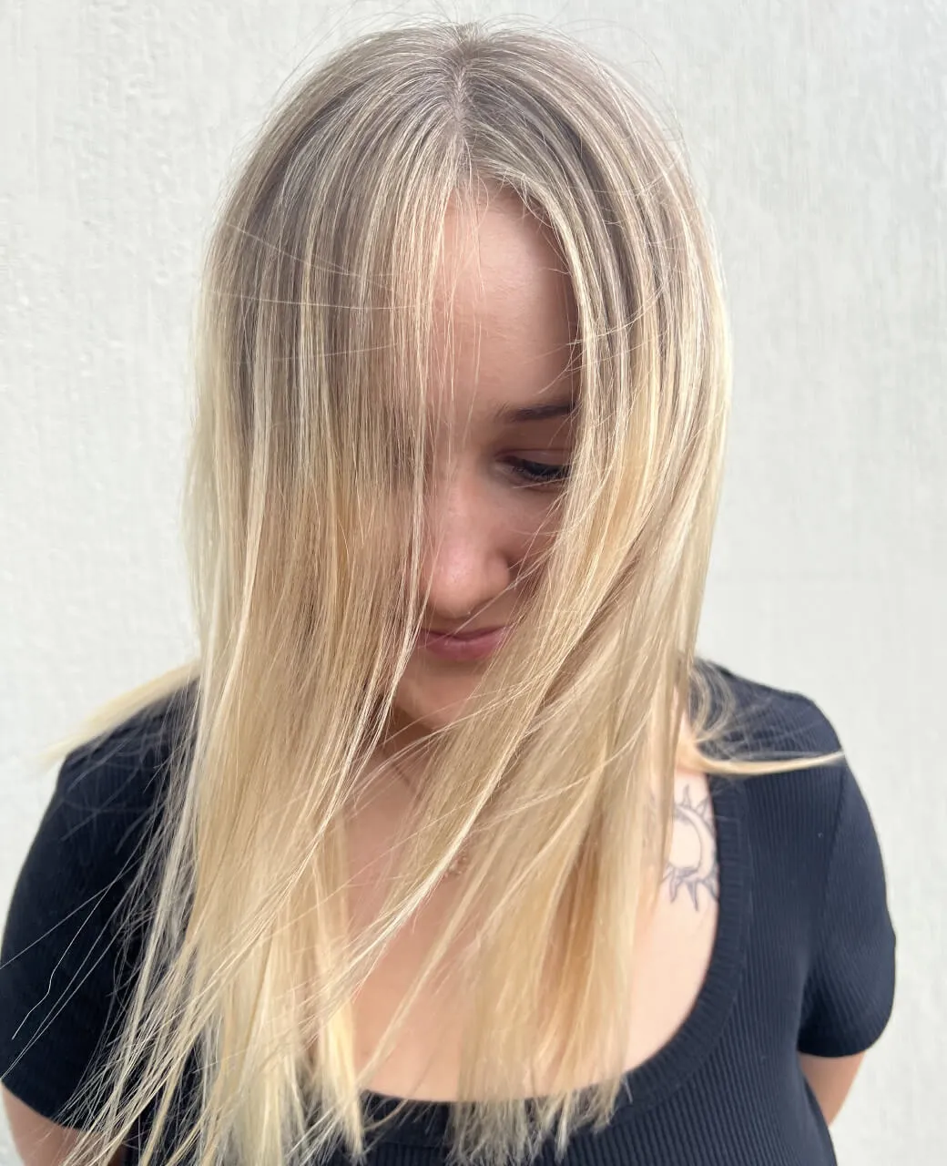 Sleek natural blonde with seamless root blend and foil highlights styled at Jura Draco Gold Coast salon