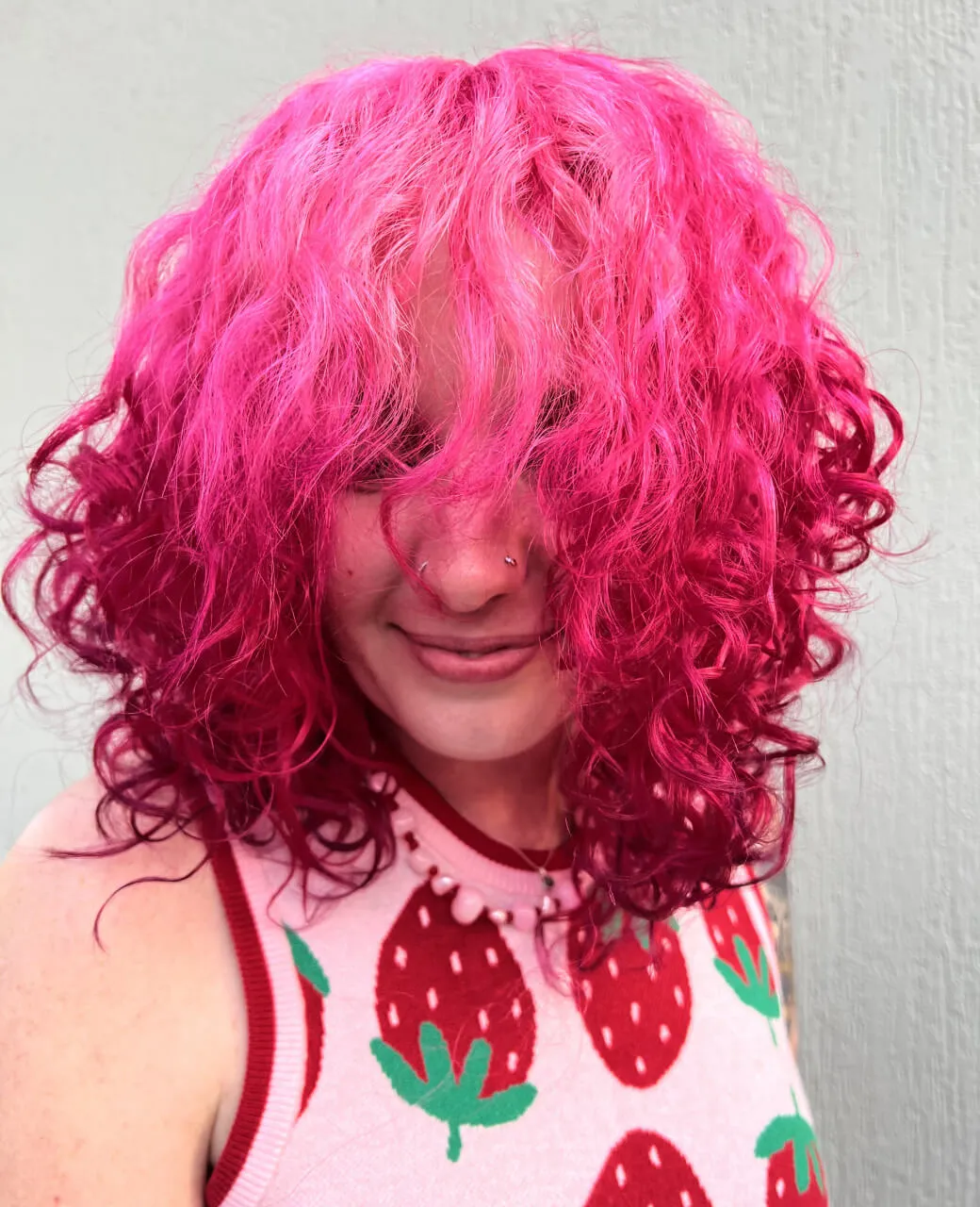 Vivid hot pink creative hair colour on curly textured hair by Jura Draco Gold Coast colour specialists