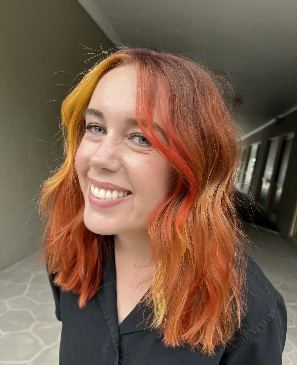 Bold copper and orange creative colour with golden face-framing highlights at Jura Draco Gold Coast salon