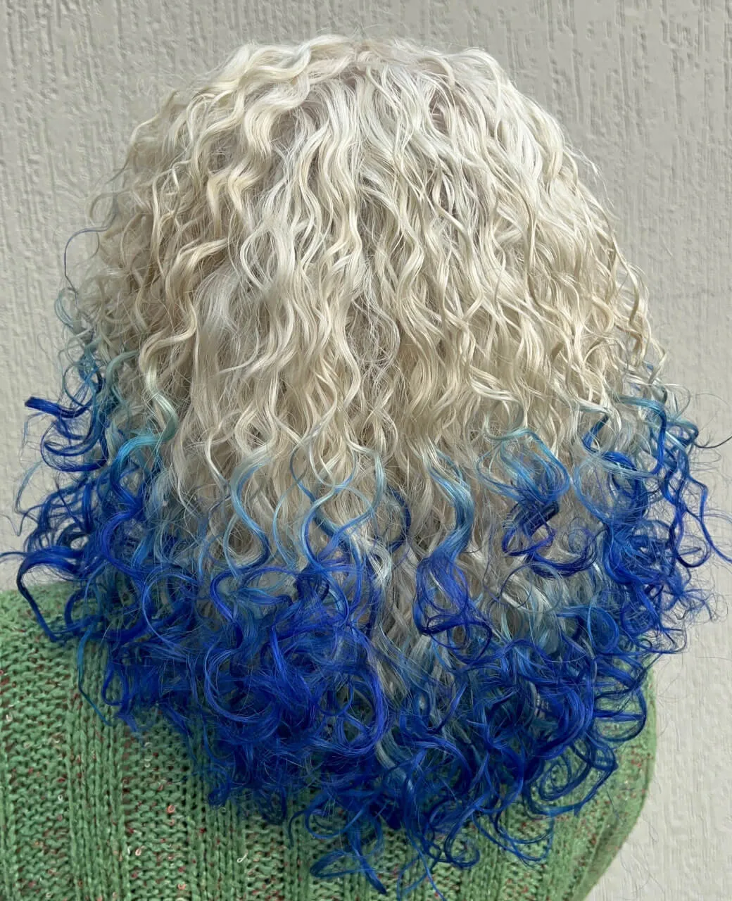 Platinum blonde to electric blue ombre creative colour on curly hair at Jura Draco Gold Coast salon