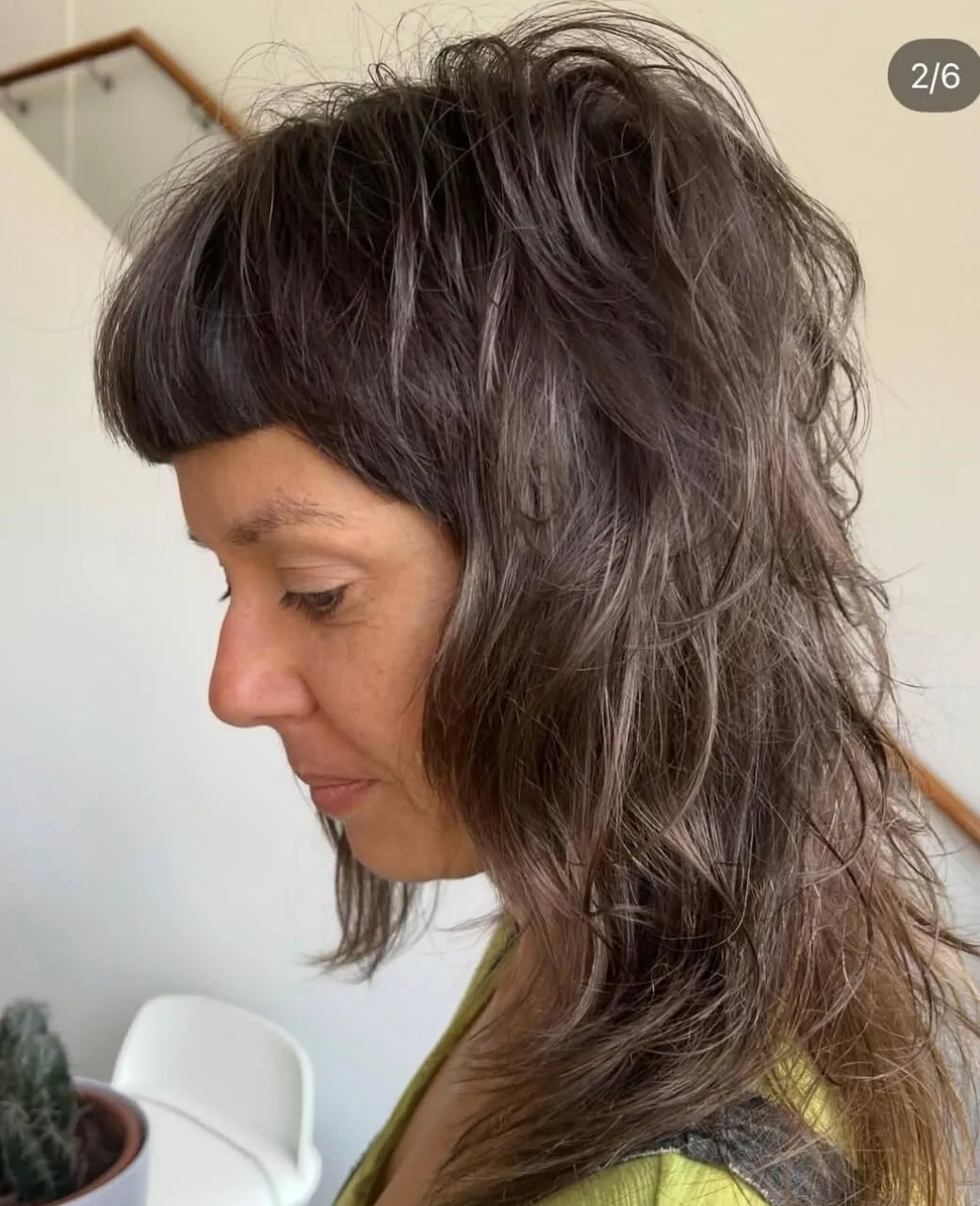 Layered shaggy mullet haircut with fringe on medium-length brunette hair by Jura Draco Gold Coast