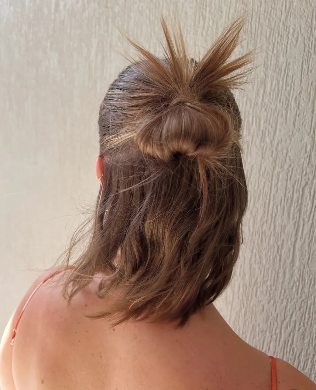 Half-up bun with natural texture on medium-length hair styled for an event at Jura Draco Gold Coast