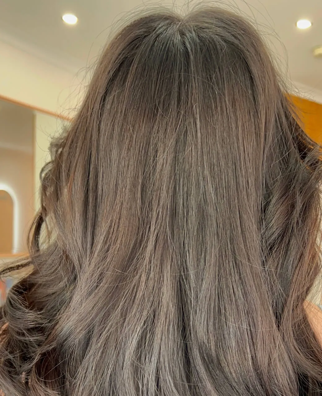 Silky smooth brunette hair with healthy shine after a nourishing hair treatment at Jura Draco Gold Coast salon