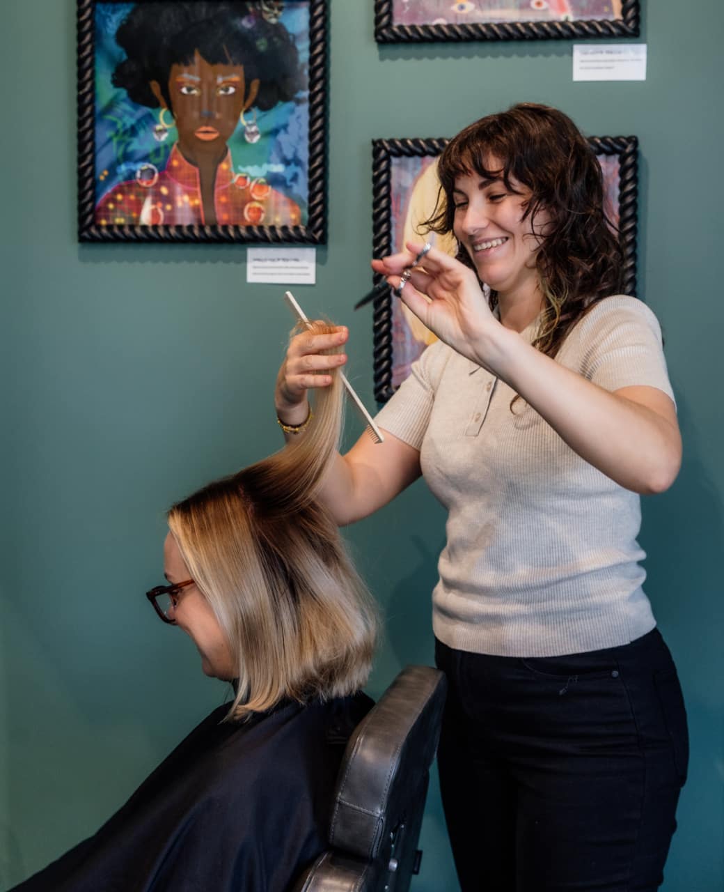 Hairstylist cutting a blonde bob for a client at Jura Draco salon in Labrador, Gold Coast