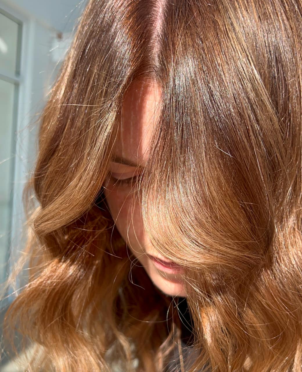 Glossy copper-brown tint colour with soft waves on mid-length hair at Jura Draco Gold Coast salon