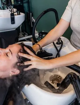 Relaxing scalp massage with steam during a hair treatment at Jura Draco Gold Coast salon