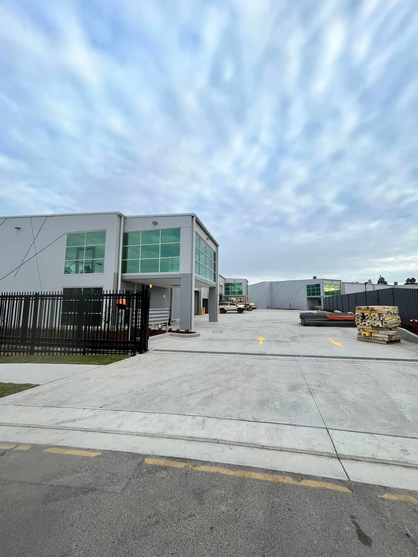 Modern car dealership building with large glass windows and signs for Mercedes-Benz and Marshalls.