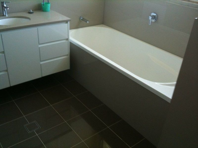 Modern car dealership building with large glass windows and signs for Mercedes-Benz and Marshalls.