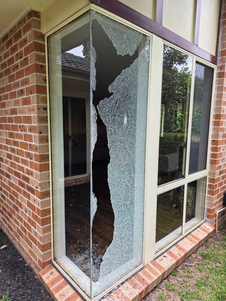 Modern commercial building with glass front displaying signs for Mercedes-Benz and Marshalls under a clear blue sky.
