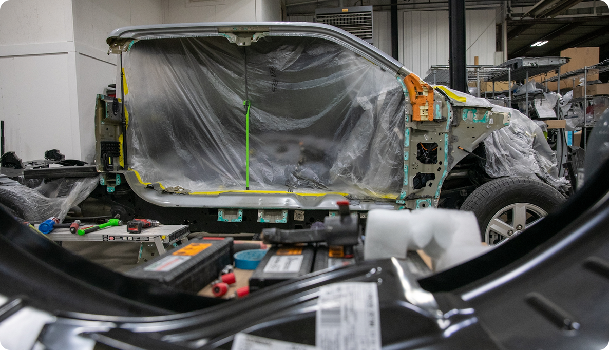 Image of full side of Ford truck completely dismantled from crash in the Blue Cell of the K-ceps Granville location.