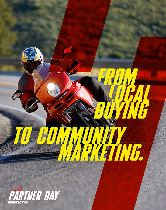 Motorcyclist leaning into a curve on a road with overlay text reading 'From local buying to community marketing.' and 'Havas Partner Day 2025'.