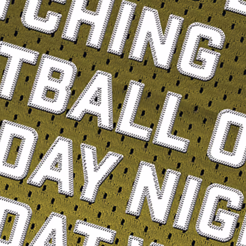 Close-up of a perforated fabric with white, bold, outlined text in a varsity style.